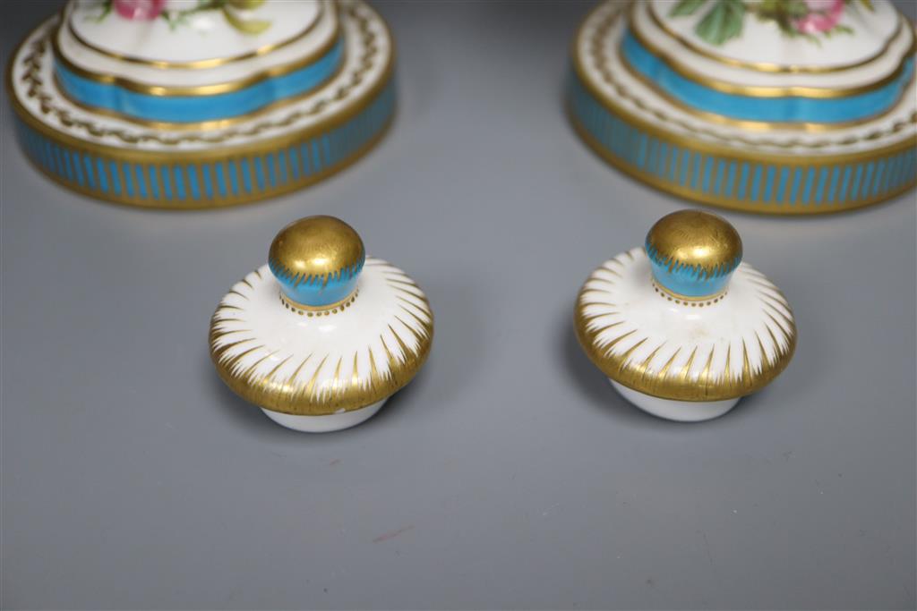 A pair of Minton style ovoid vases and covers, decorated with roses, 37cm